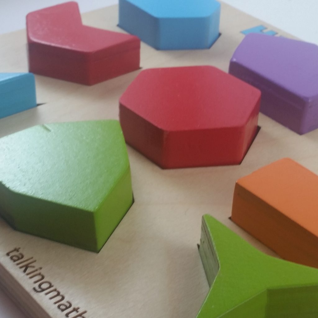 Another colorful wooden puzzle for young children. This one says "Hexagons" at the top and has a diverse collection of hexagons, including both concave and convex hexagons.