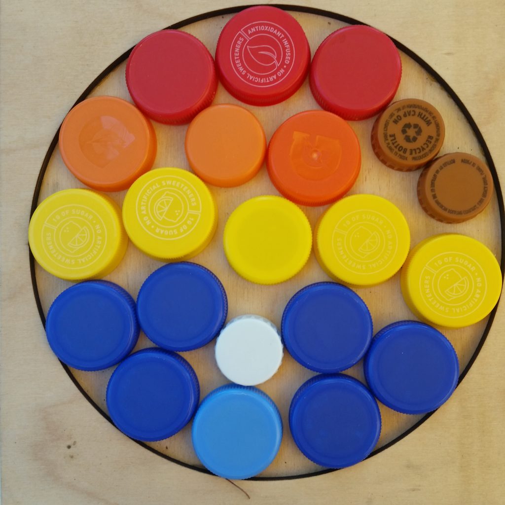 A colorful collection of bottle caps artfully arranged in a large circular frame