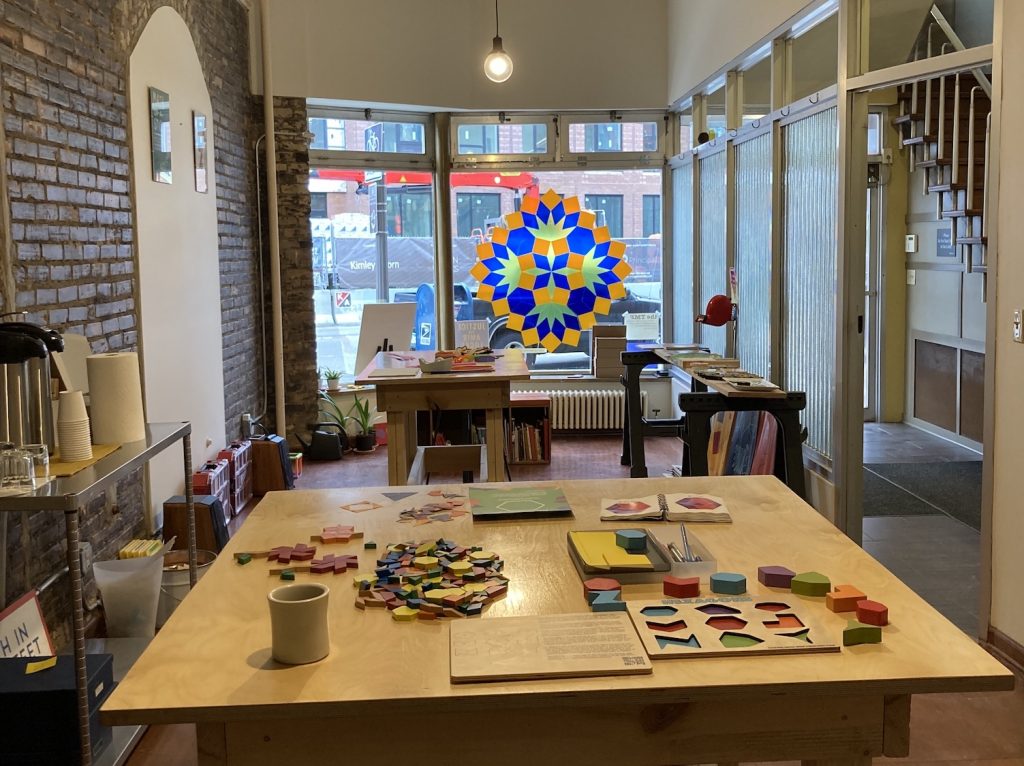 A long, skinny, brighly lit room set up for math play.