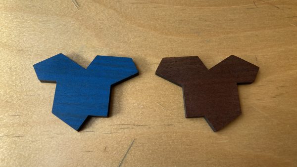 A tile and its reflected image. One is blue; the other is brown.