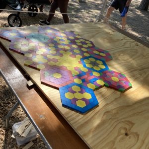 The beginning of the mosaic. Dappled light is cast on a dozen or so composed hexagons.